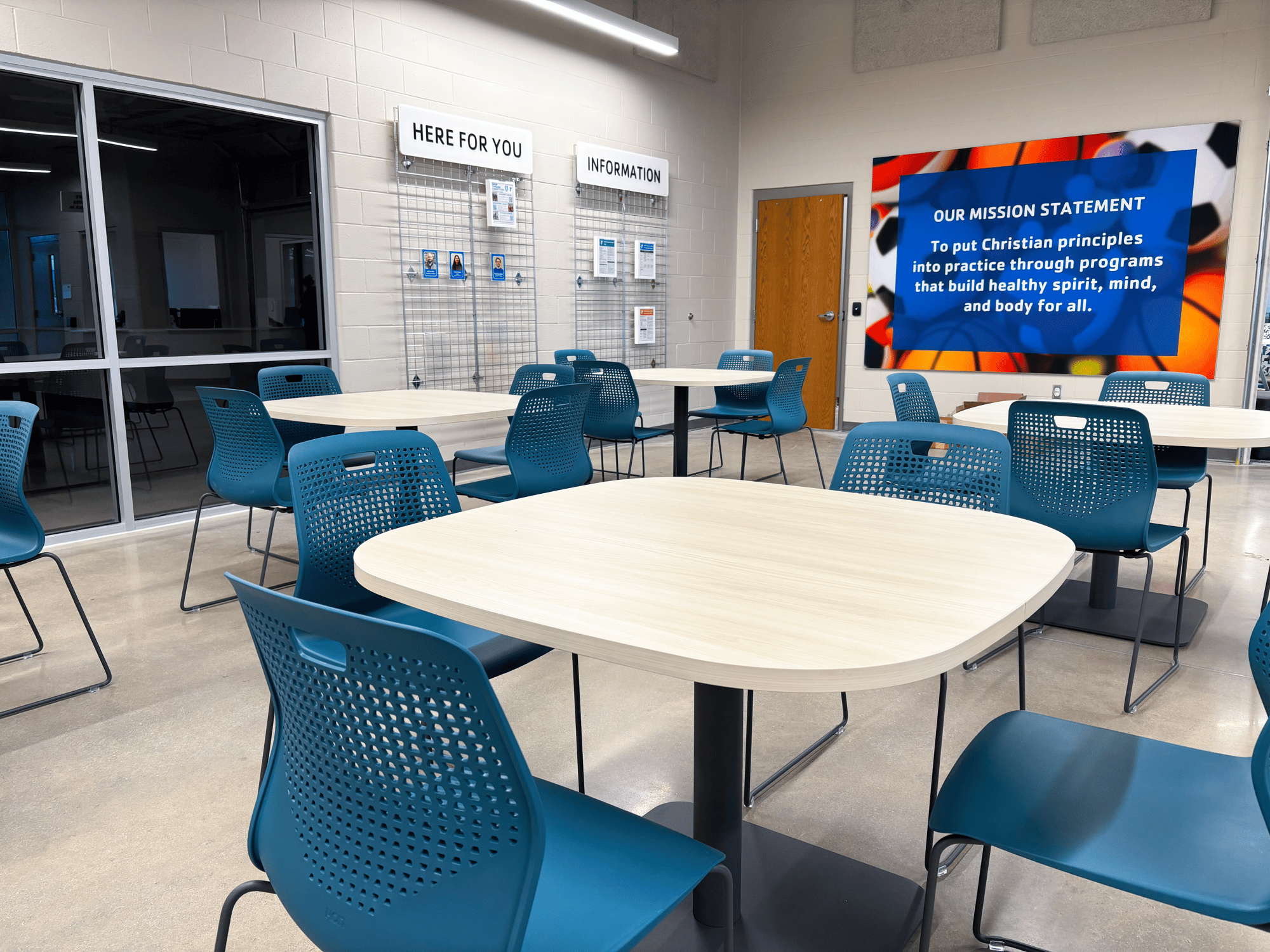 A mission statement hangs on the wall behind rows of tables and chairs A mission statement hangs on the wall behind rows of tables and chairs