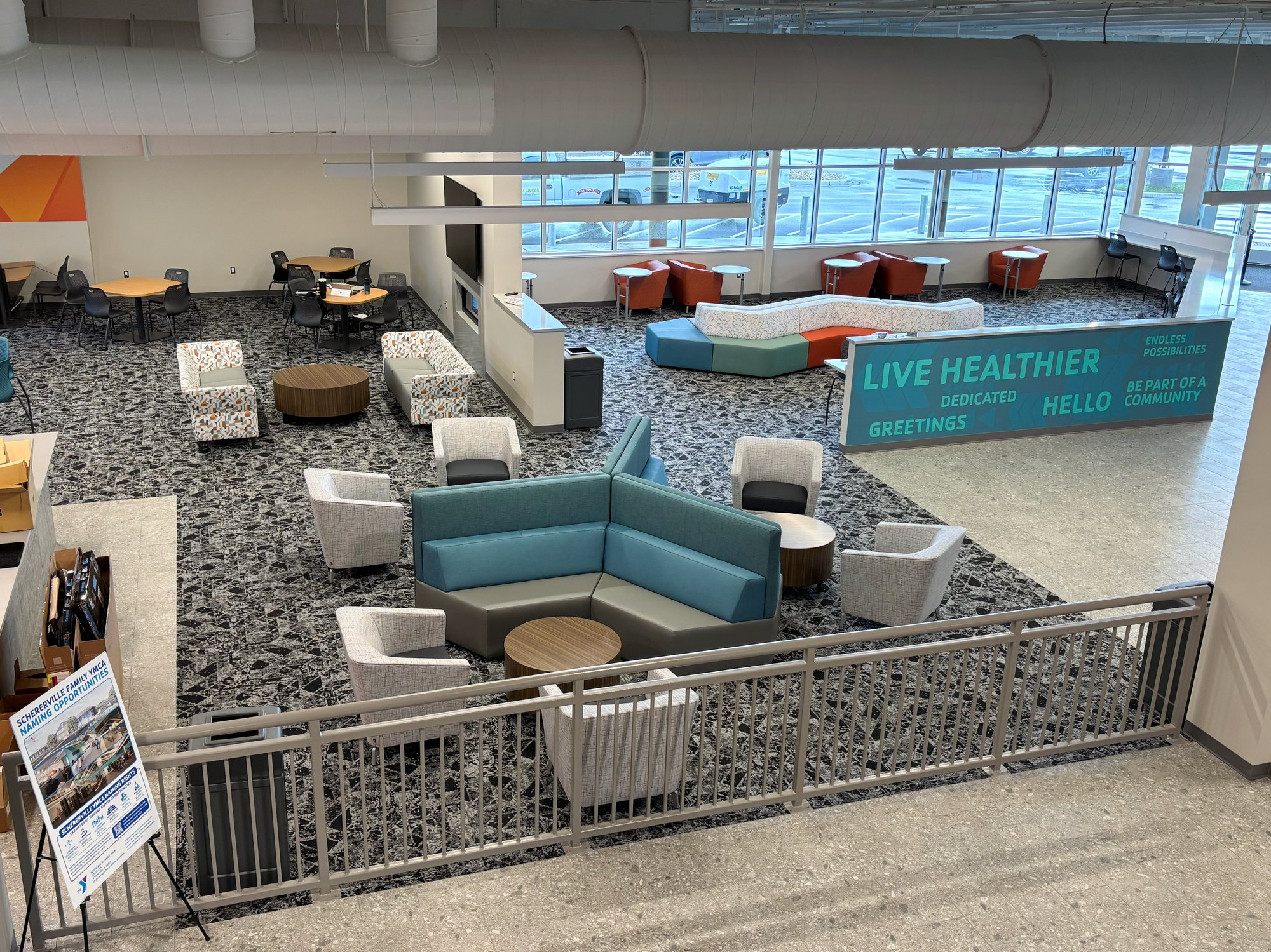 Arial view of the lobby with various teal, orange, and white furnishings. Arial view of the lobby with various teal, orange, and white furnishings.