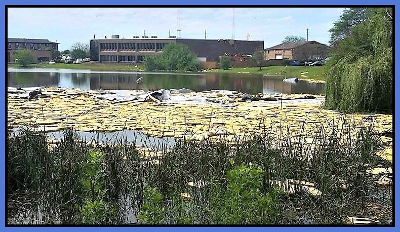 The roofing of the old DPOE headquarters in the lake after a tornado.