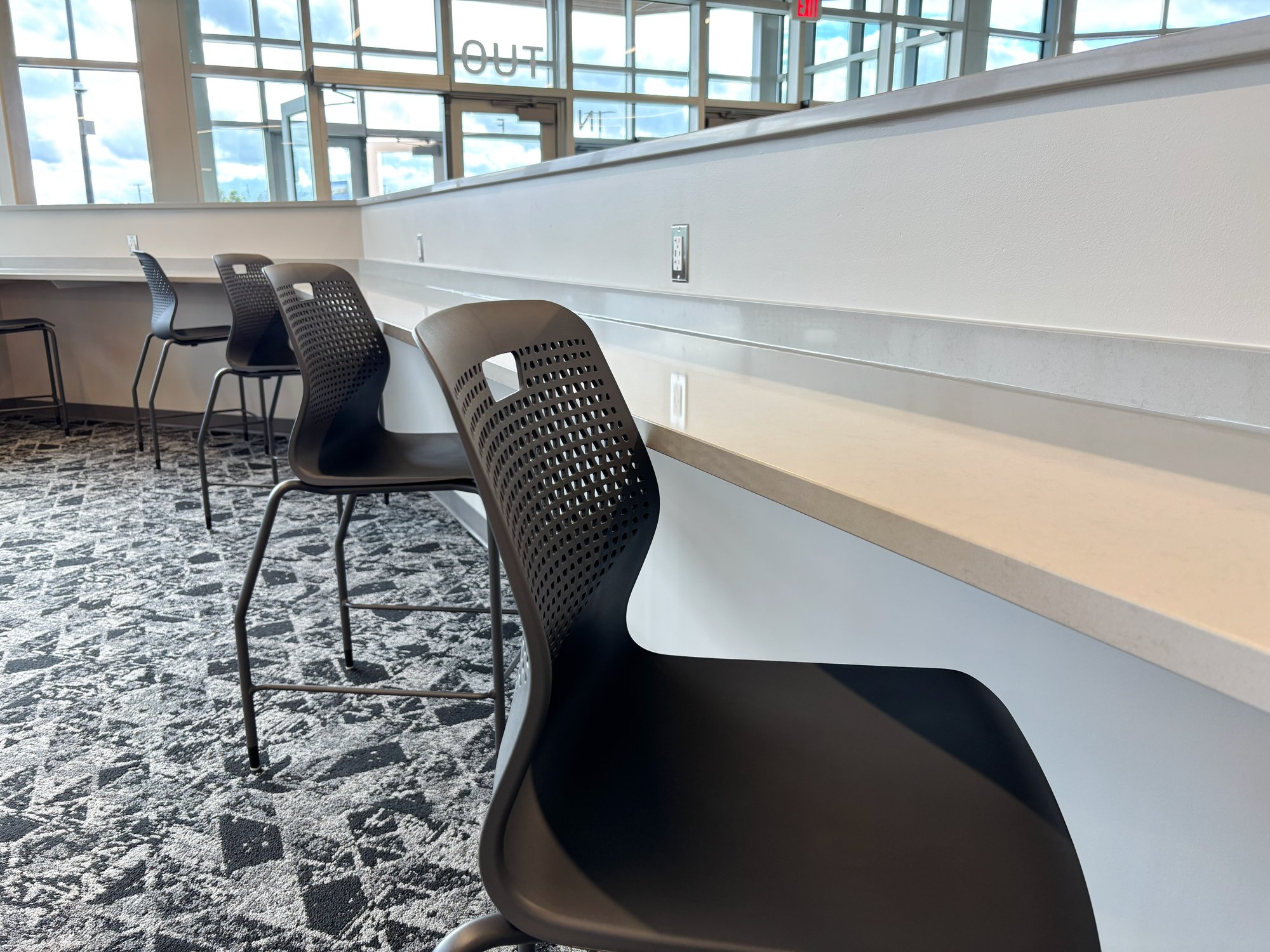 Bar-height chairs lined up at the lobby counter Bar-height chairs lined up at the lobby counter