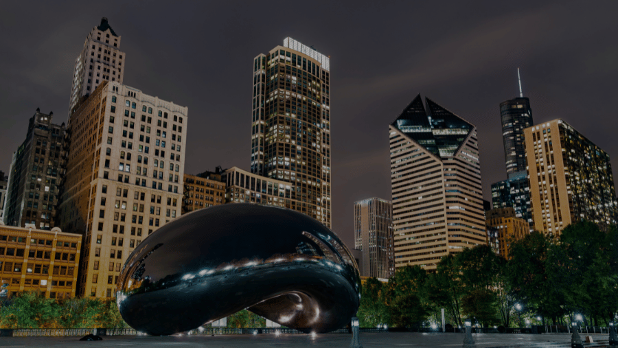 A night photo of Chicago and the famous Chicago Bean Sculpture