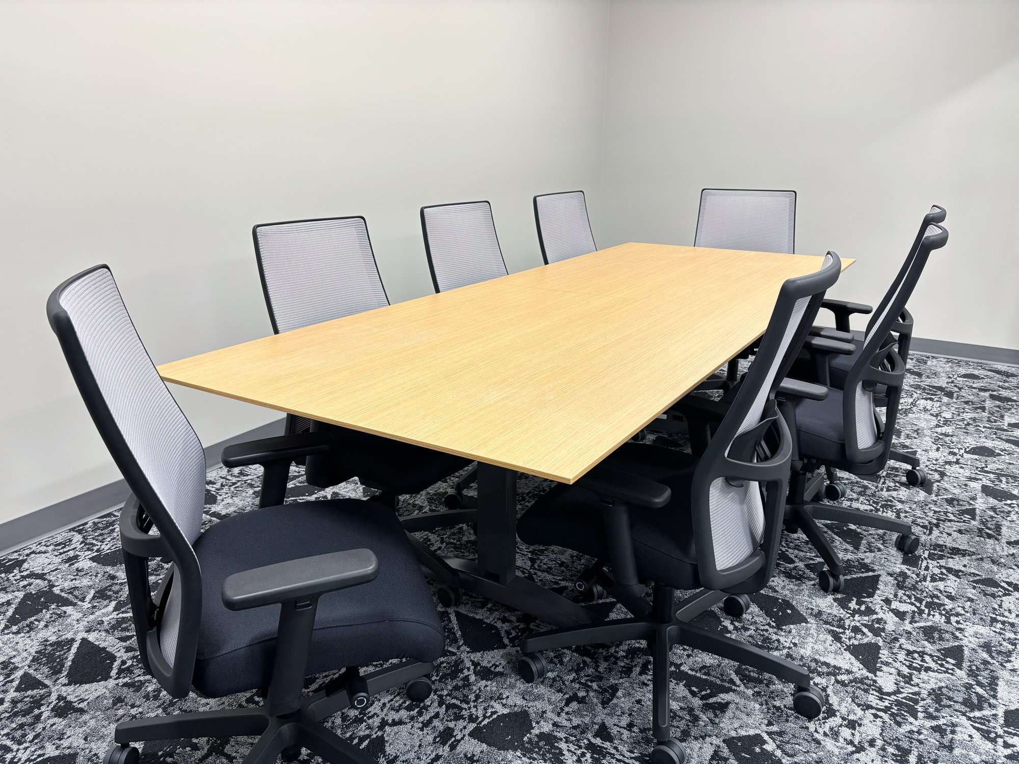 Conference room with a rectangular table and eight chairs Conference room with a rectangular table and eight chairs