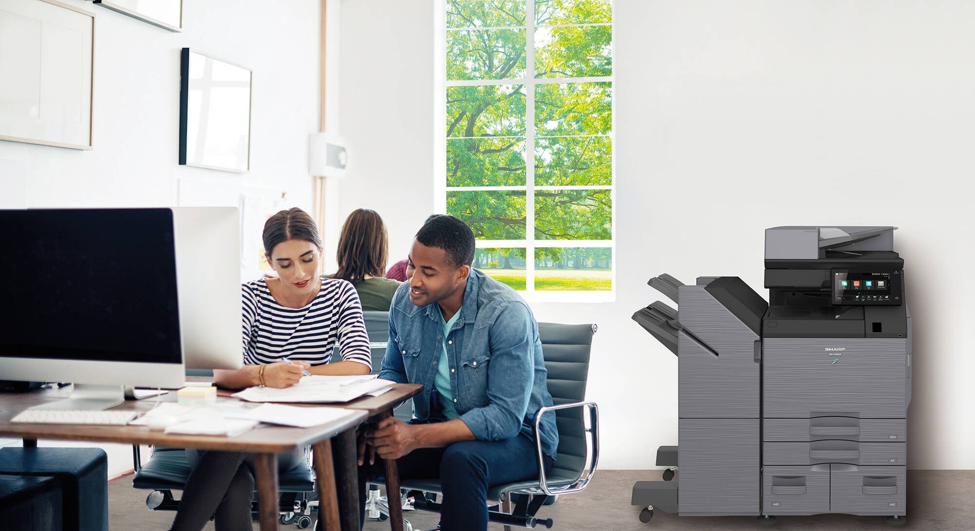 Coworkers collaborating in open office space