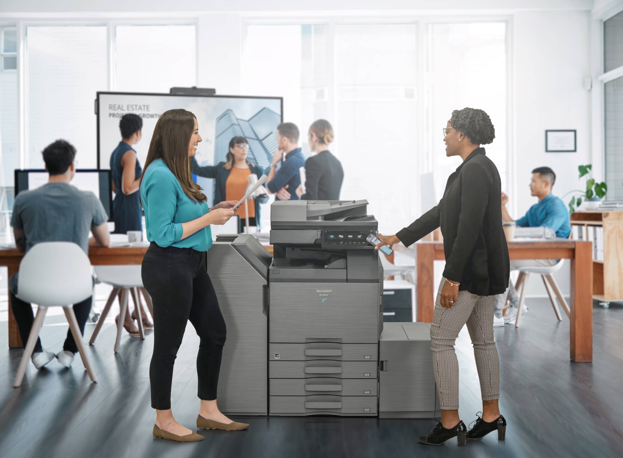 Coworkers collaborating over MFP
