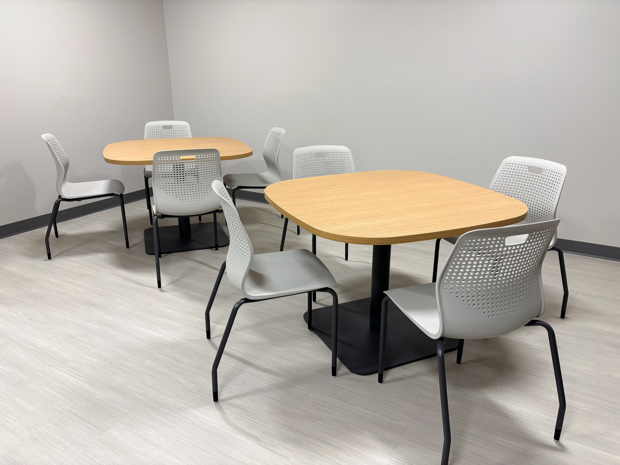 Break room with two tables and eight grey Hon Etch chairs Break room with two tables and eight grey Hon Etch chairs