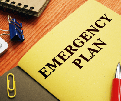 A booklet on a desk that says "Emergency Plan"