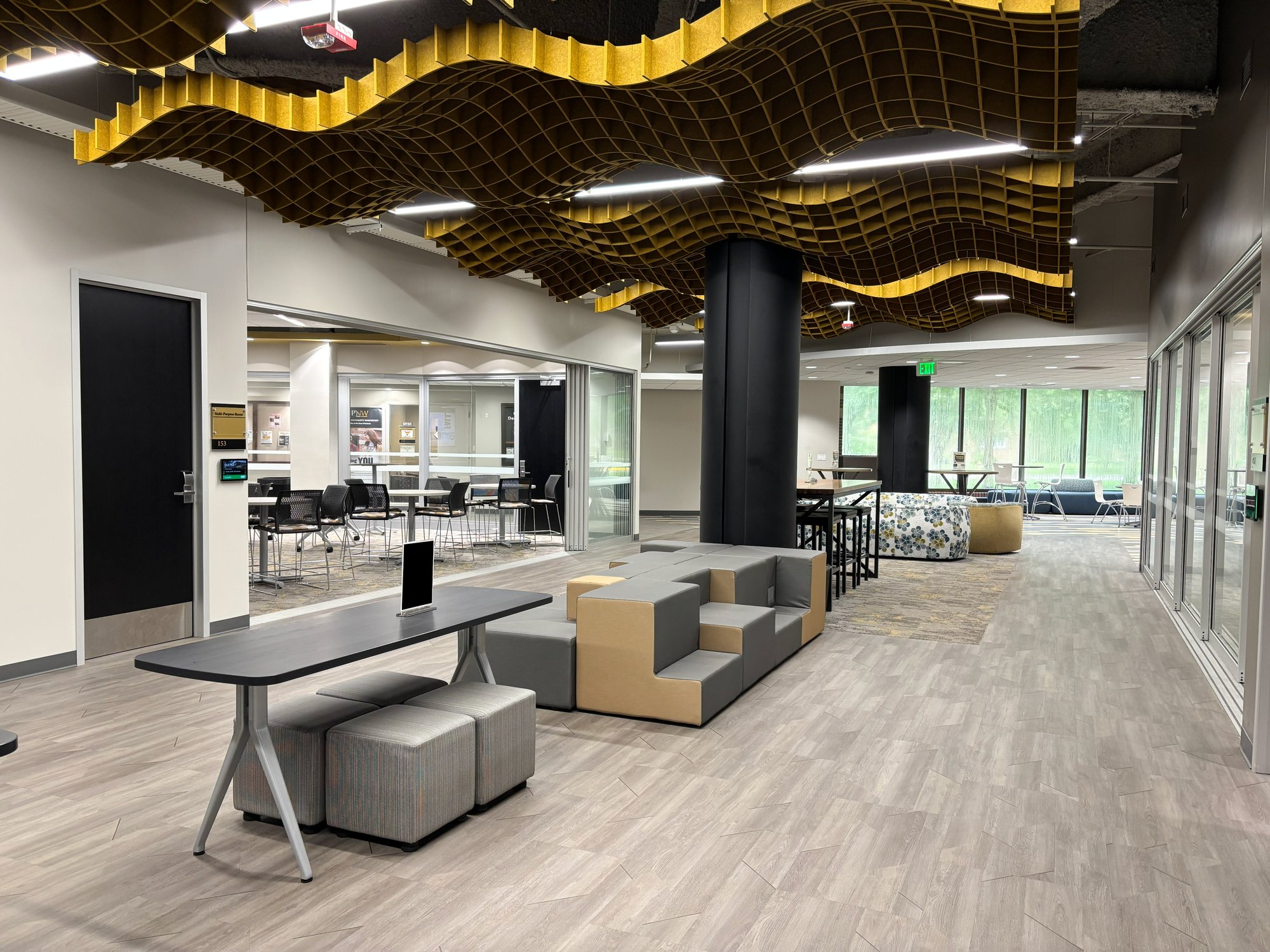 Hallway with waffle noise dampening and various types of seating and tables Hallway with waffle noise dampening and various types of seating and tables