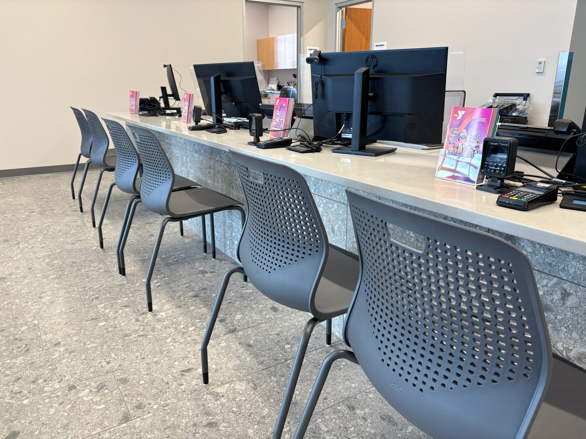 Guest registration counter with a row of grey Hon Etch chairs in front of it Guest registration counter with a row of grey Hon Etch chairs in front of it