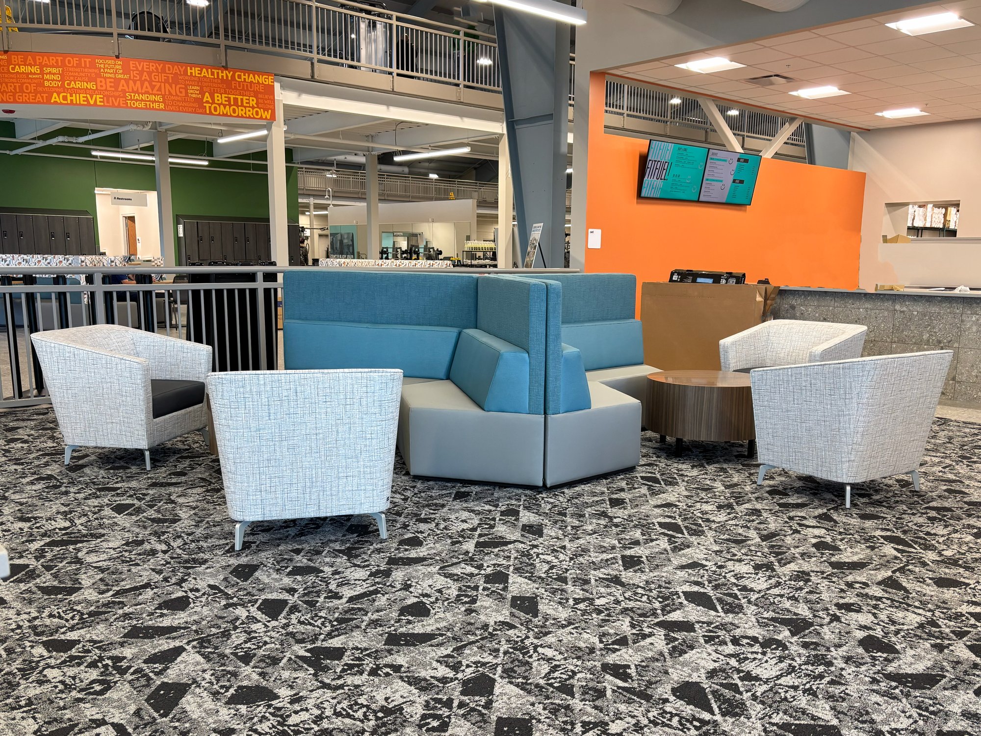 Hon Tangram seating area with white chairs surrounding it Hon Tangram seating area with white chairs surrounding it