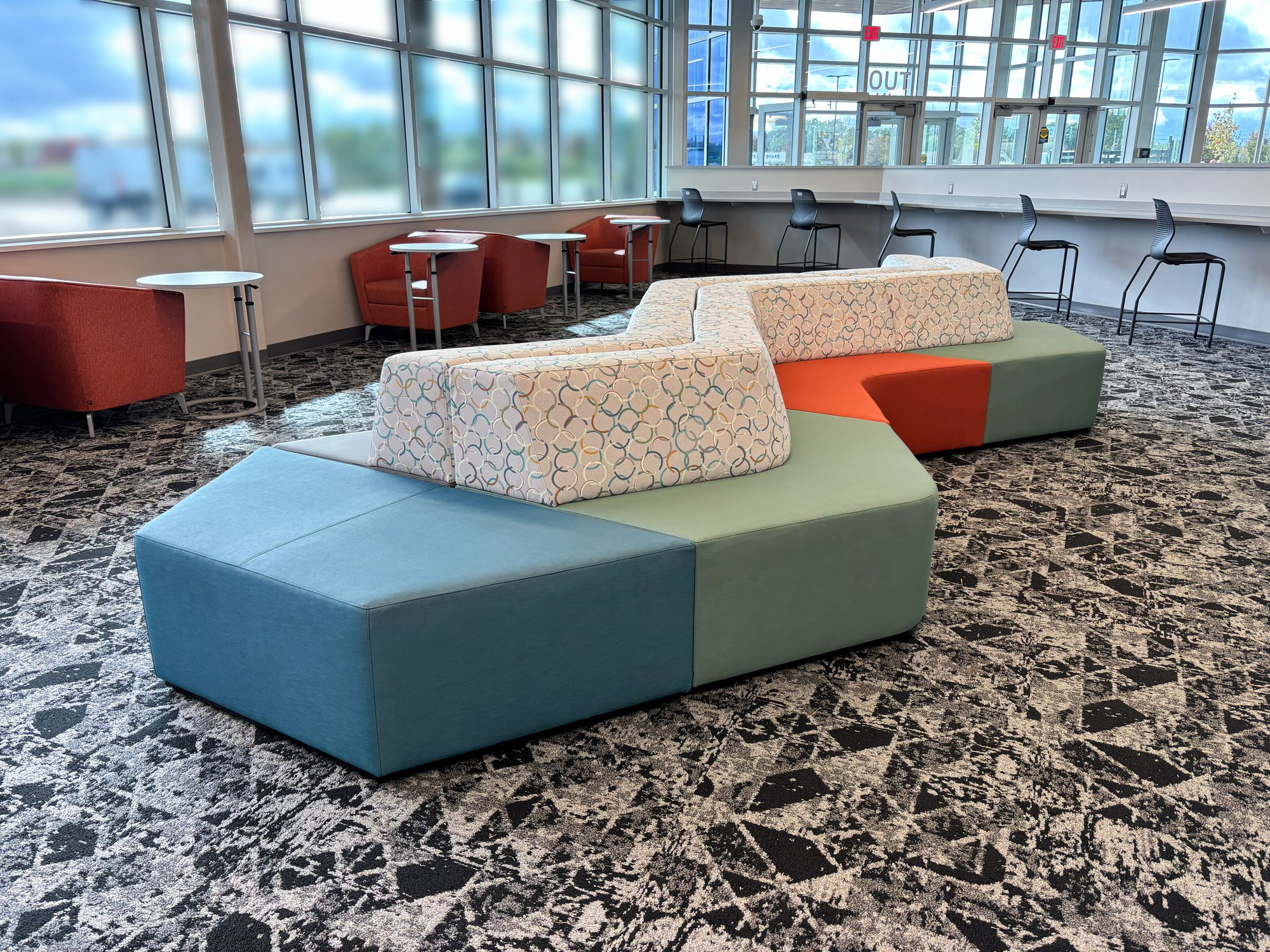 Hon Tangram lounge with teal, blue, and orange accents. Hon Tangram lounge with teal, blue, and orange accents.