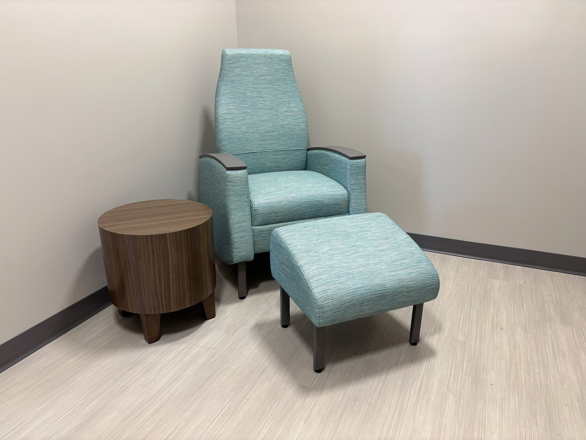 Mothers' Room with a table and a teal chair Mothers' Room with a table and a teal chair