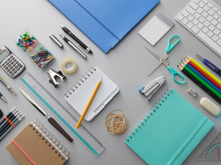 A top-down view of a desk with office supplies spread across it.