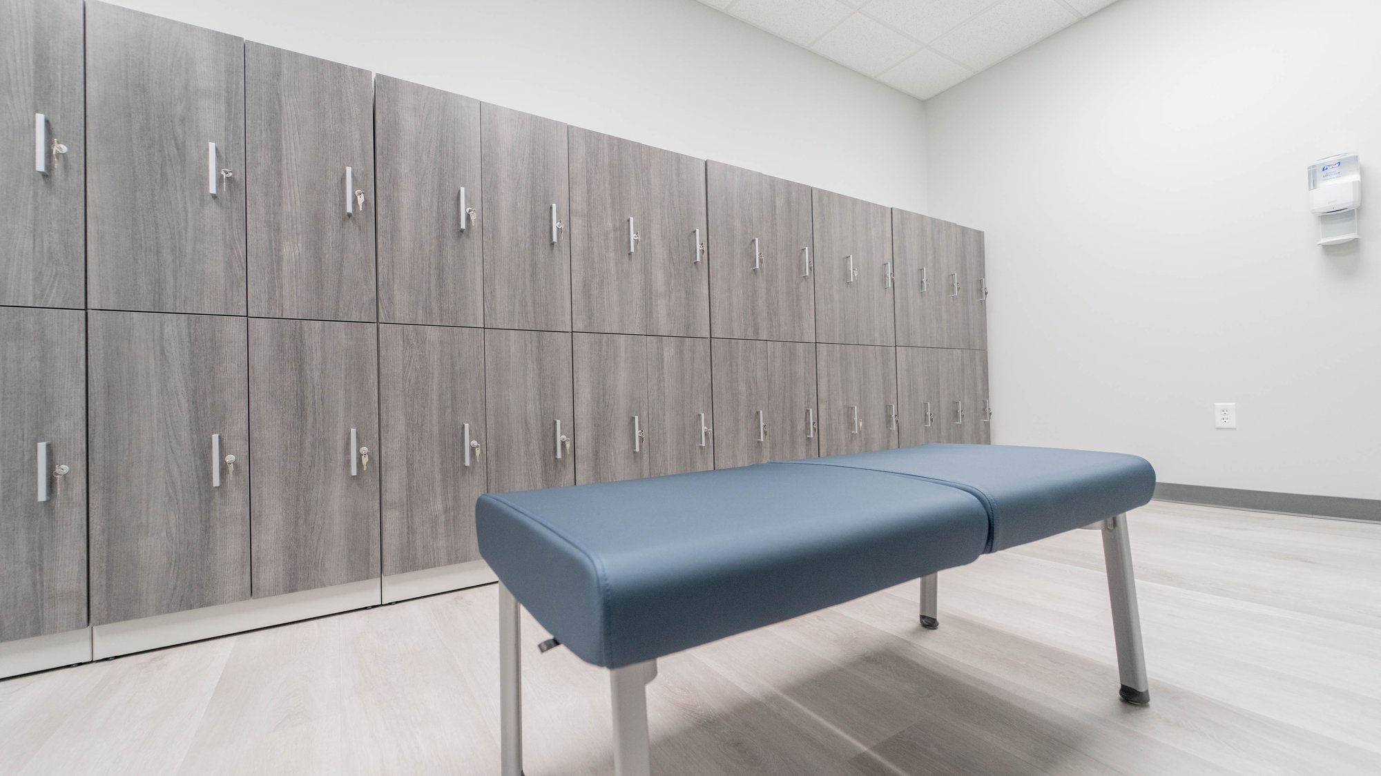 Locker wall storage with blue bench seating Locker wall storage with blue bench seating