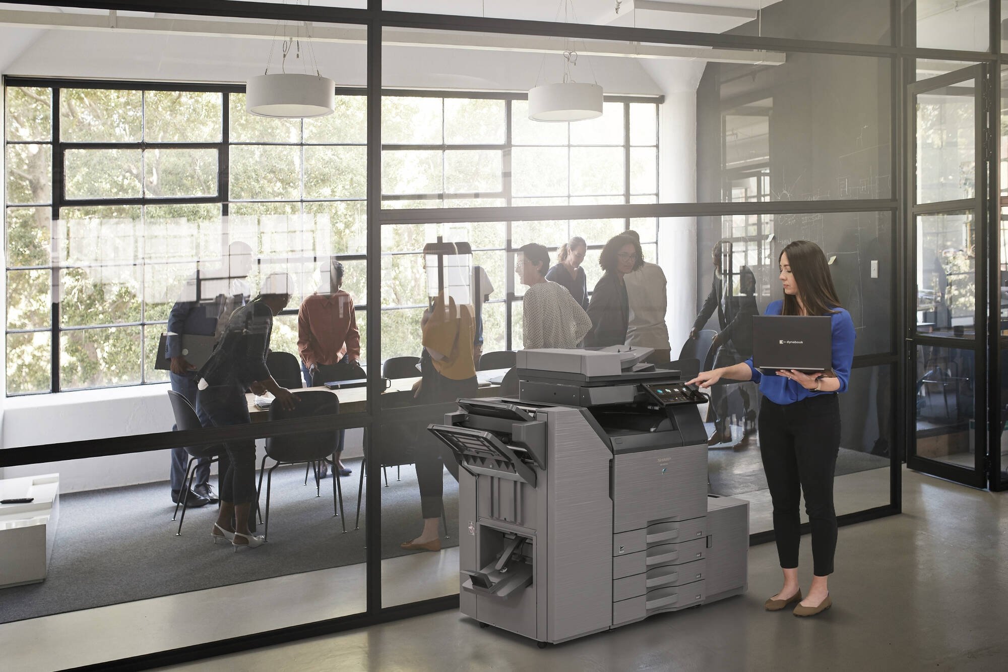 Office Worker multitasking with MFP and Dynabook