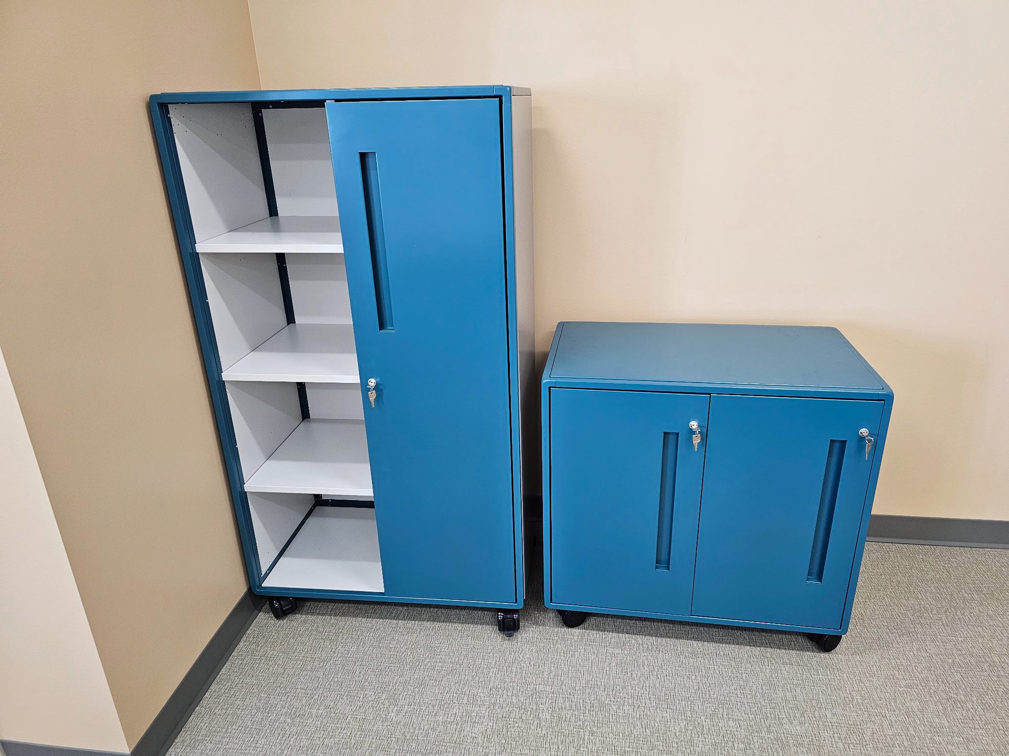 Blue storage cabinets sit flush against a wall Blue storage cabinets sit flush against a wall