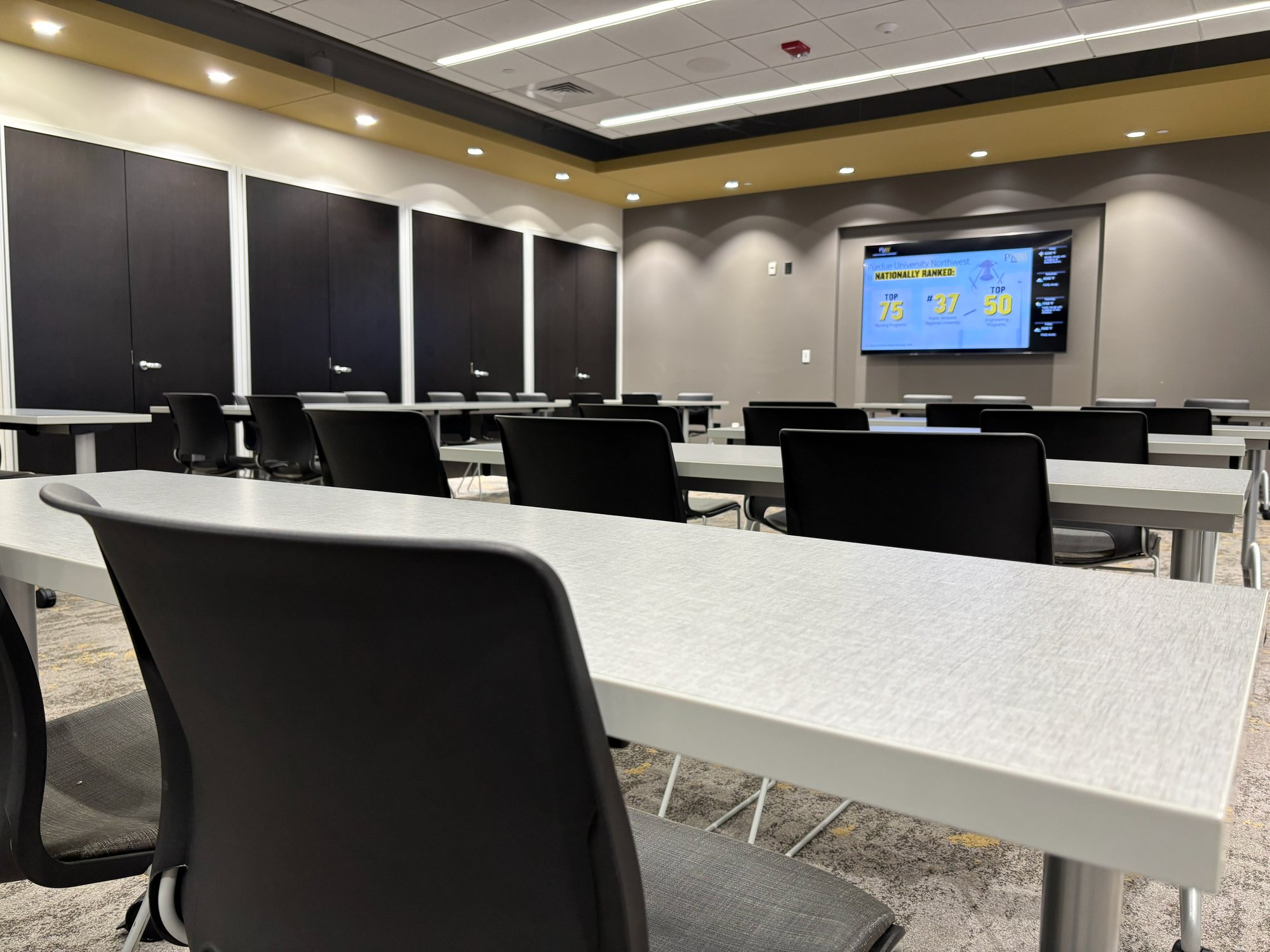 Meeting space with black chairs and grey tables Meeting space with black chairs and grey tables