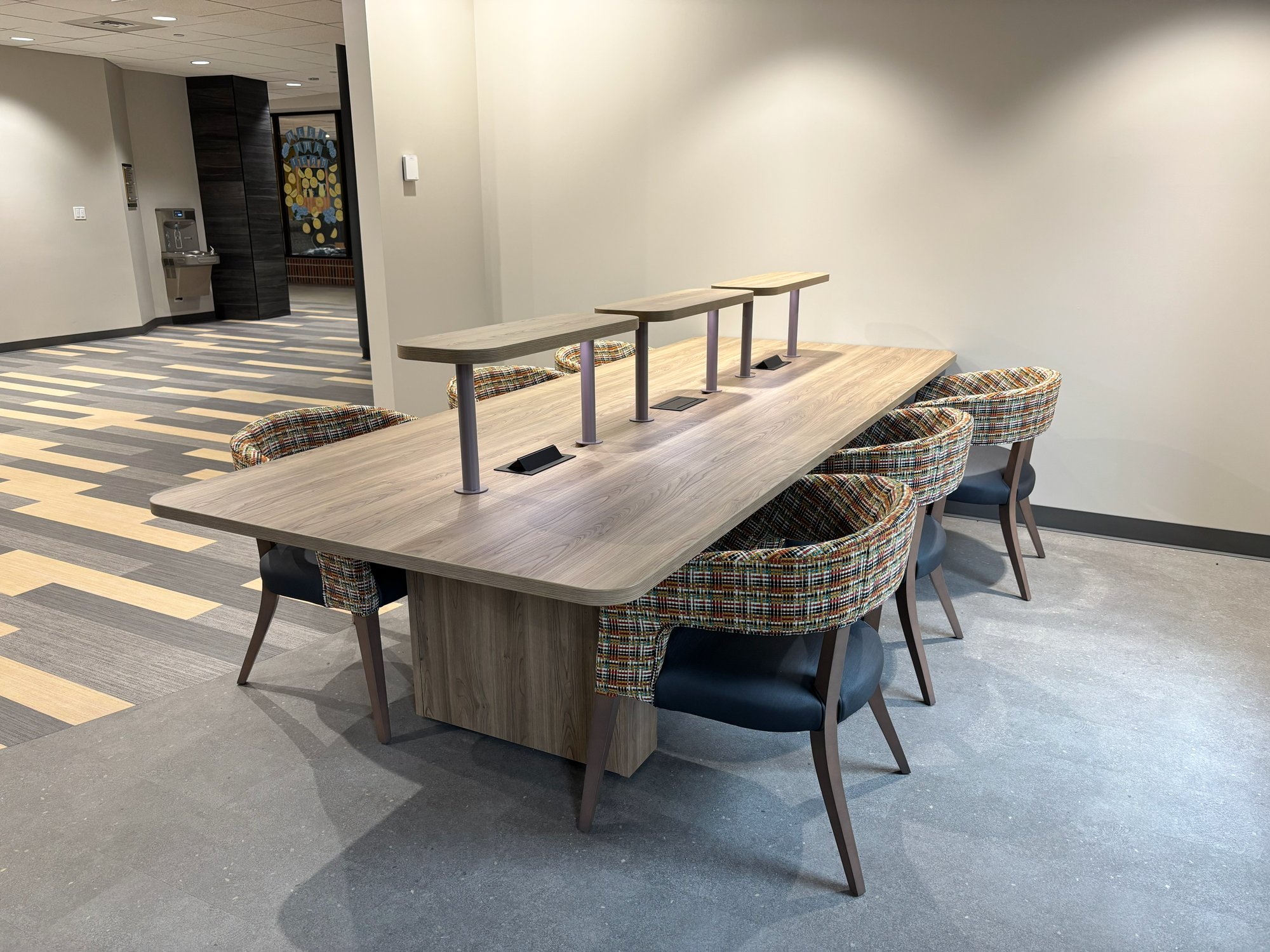 Soft seating surrounds a study table with built-in lighting Soft seating surrounds a study table with built-in lighting