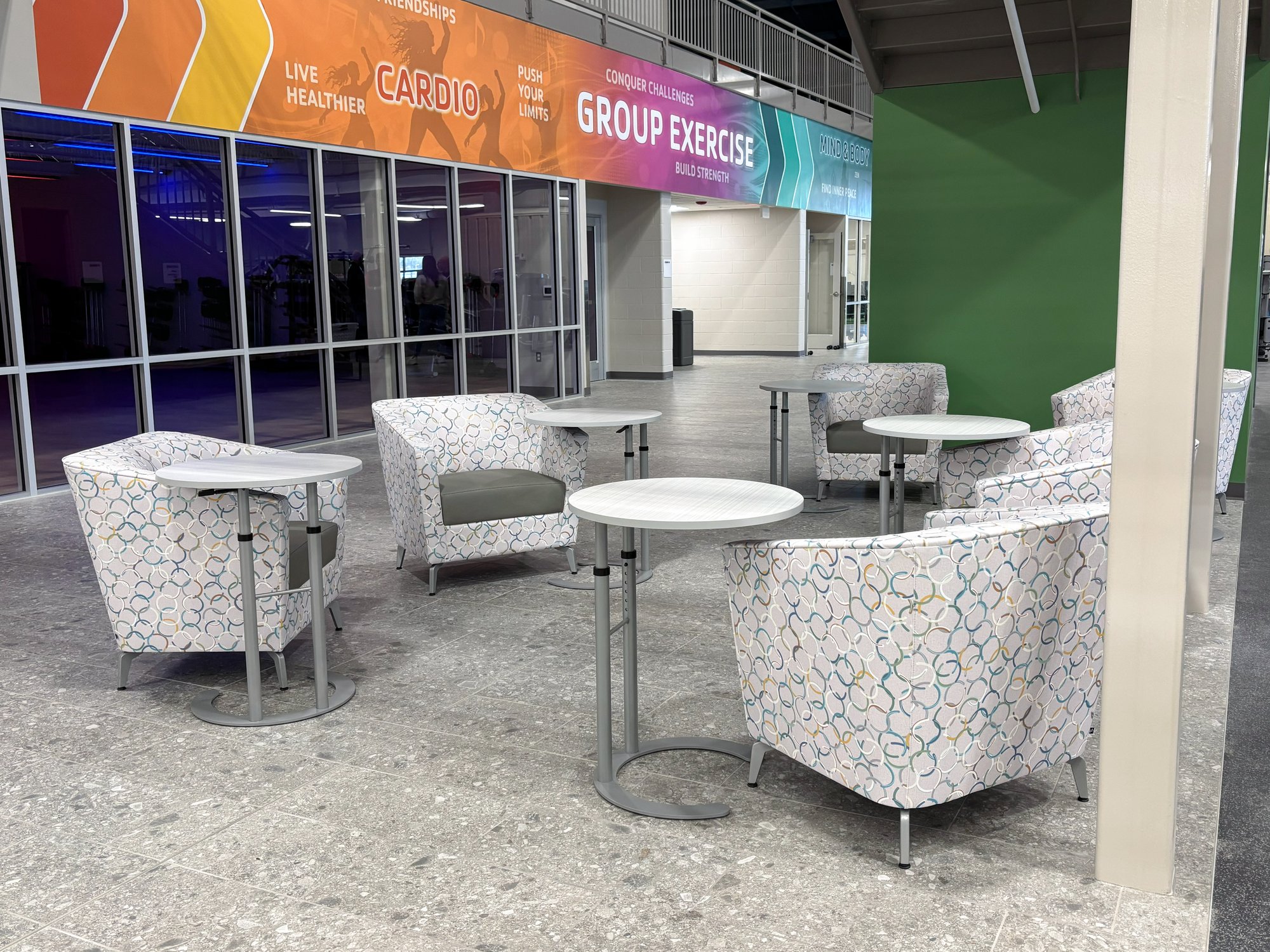 Multi-color white chairs are arranged under a staircase Multi-color white chairs are arranged under a staircase