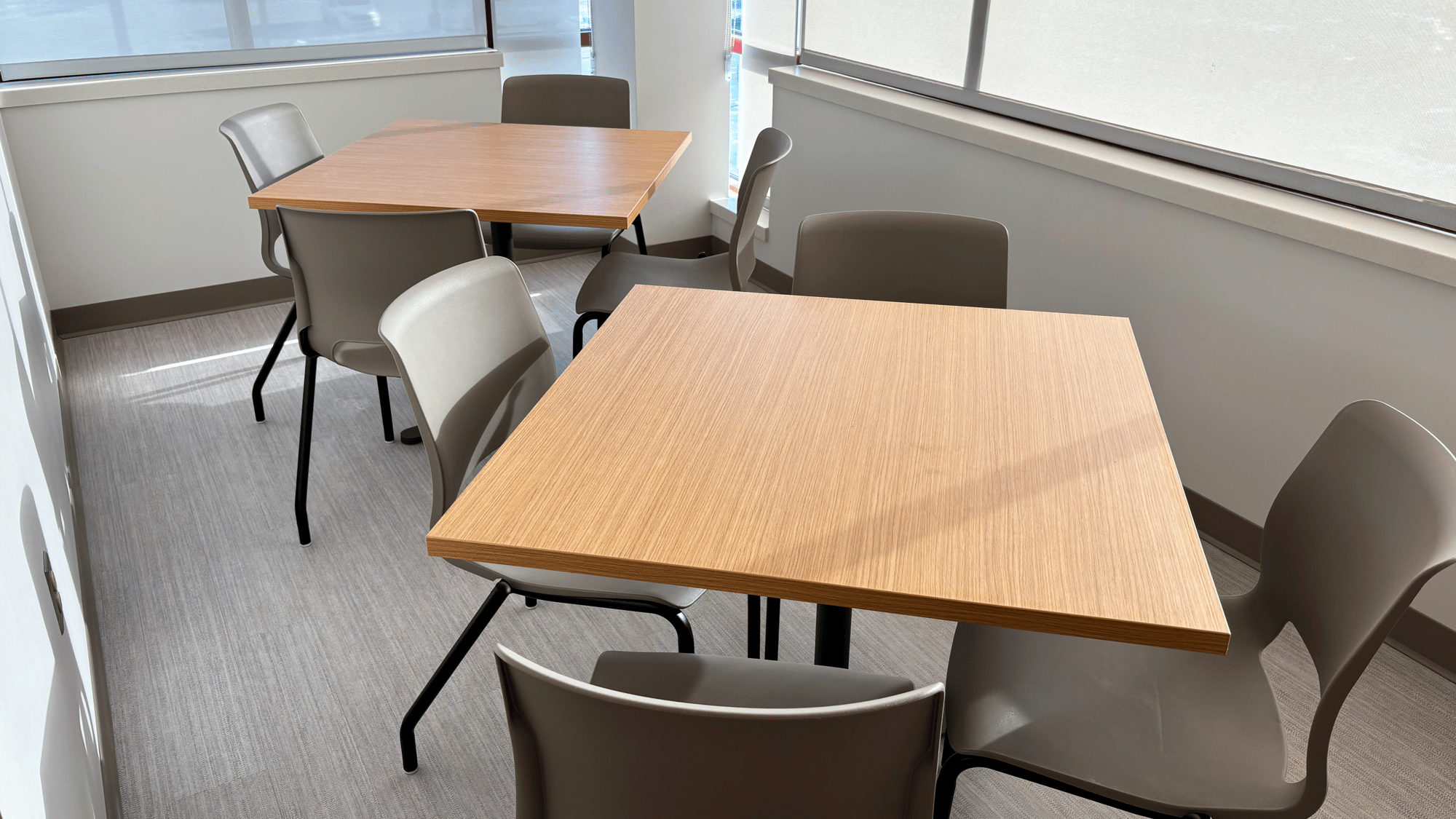 Break room with two square tables and chairs Break room with two square tables and chairs
