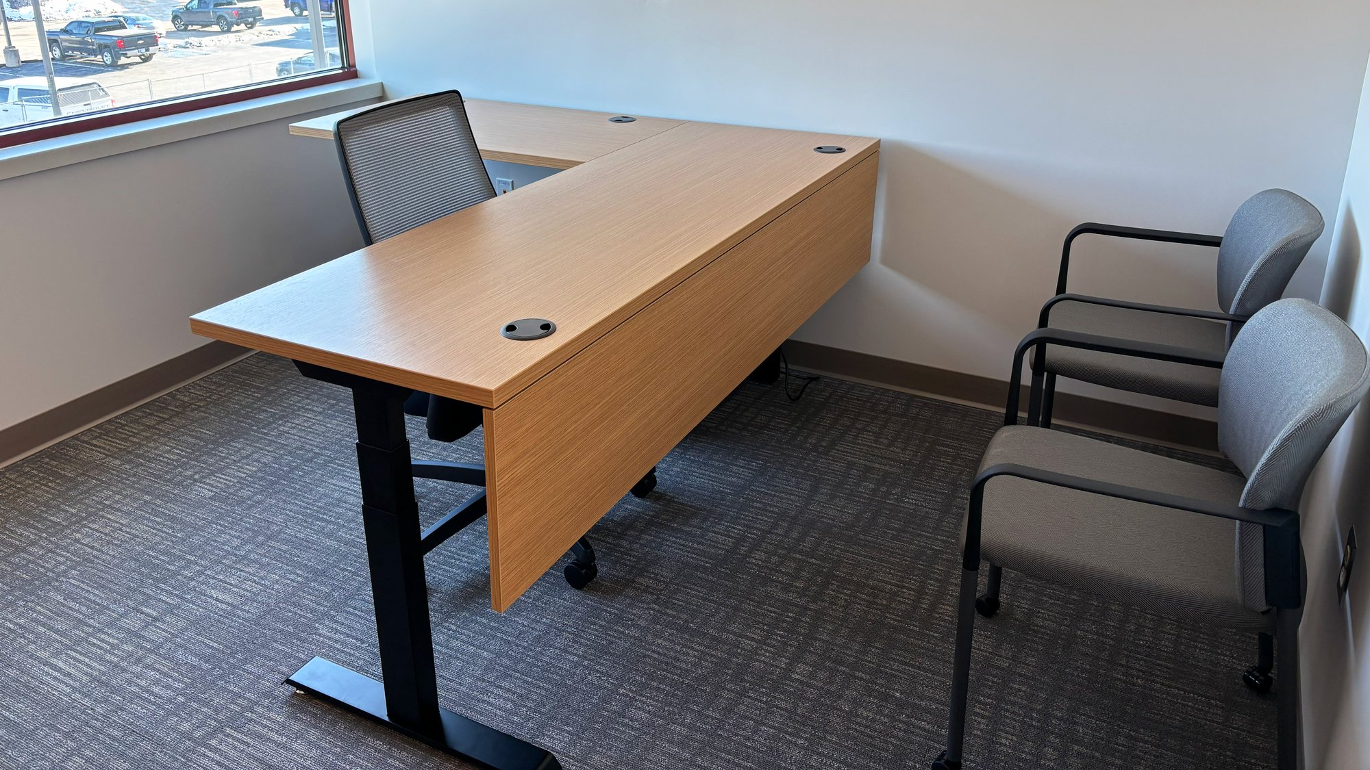 Personal office with mesh-backed rolling chair, two stationary chairs Personal office with mesh-backed rolling chair, two stationary chairs