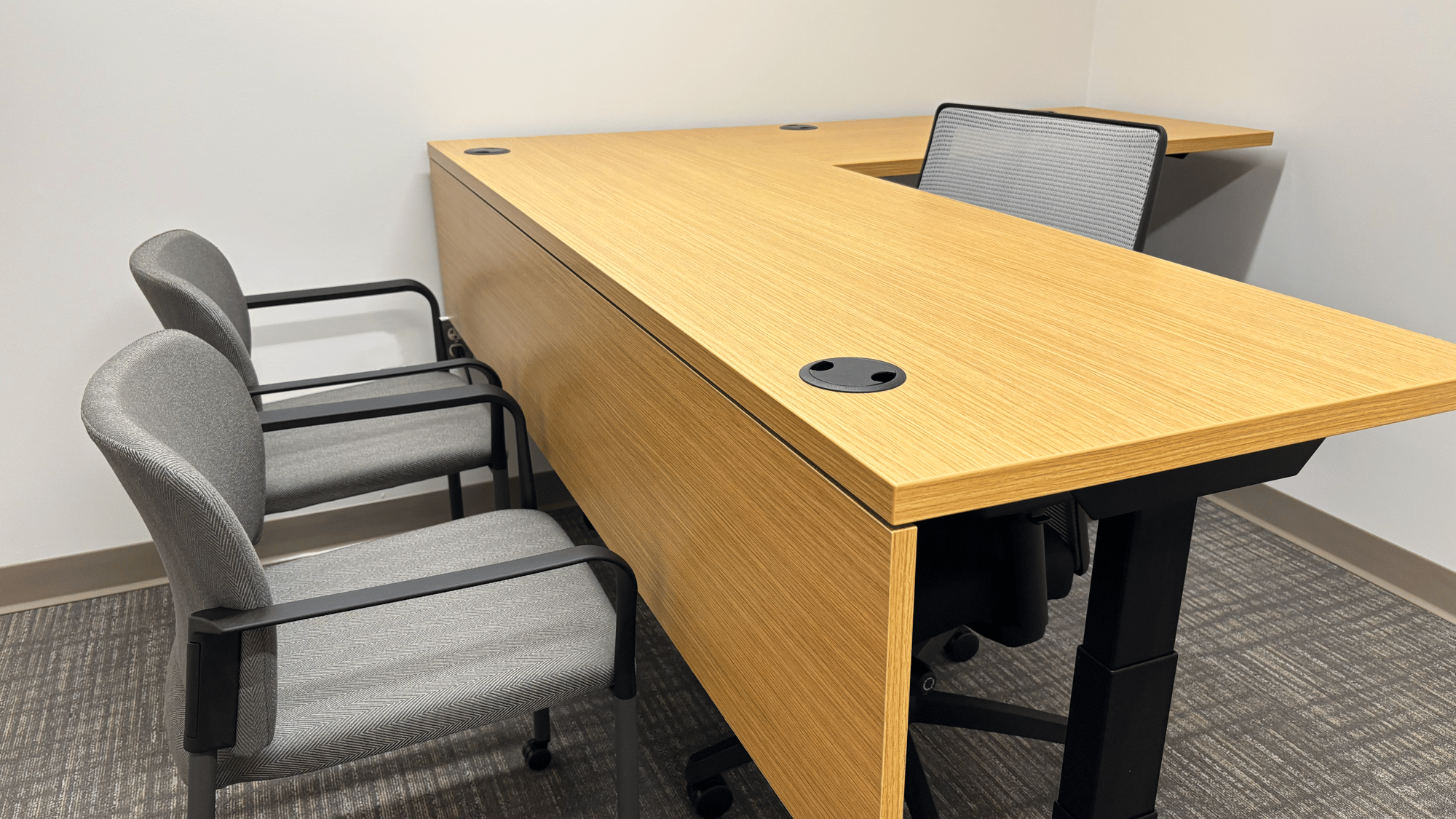 Personal office with mesh-backed rolling chair, two stationary chairs Personal office with mesh-backed rolling chair, two stationary chairs