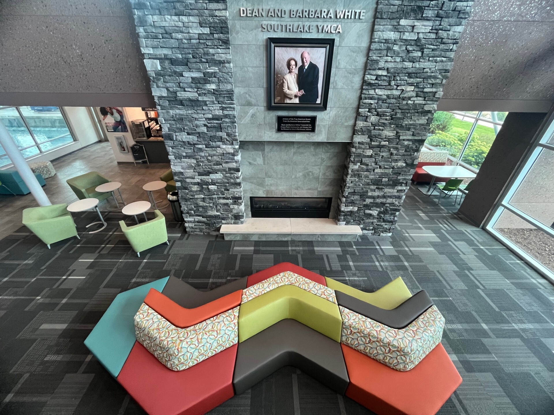 Zig-zag couch in front of a fireplace with a portrait of Dean and Barbara White hanging above it