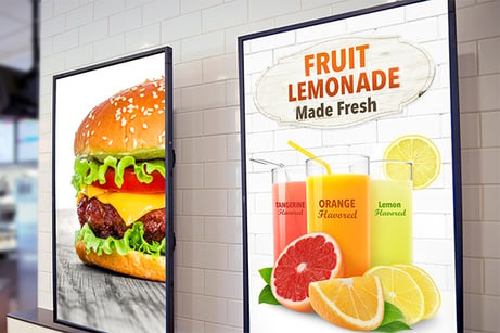 Video displays in a restaurant showing food advertisements.