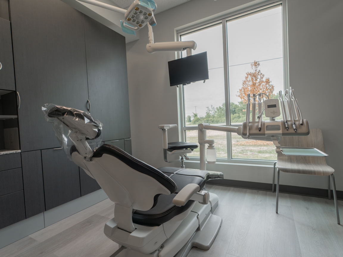 Dental exam chair sitting in an exam room with a stationary chair and optimized storage Dental exam chair sitting in an exam room with a stationary chair and optimized storage