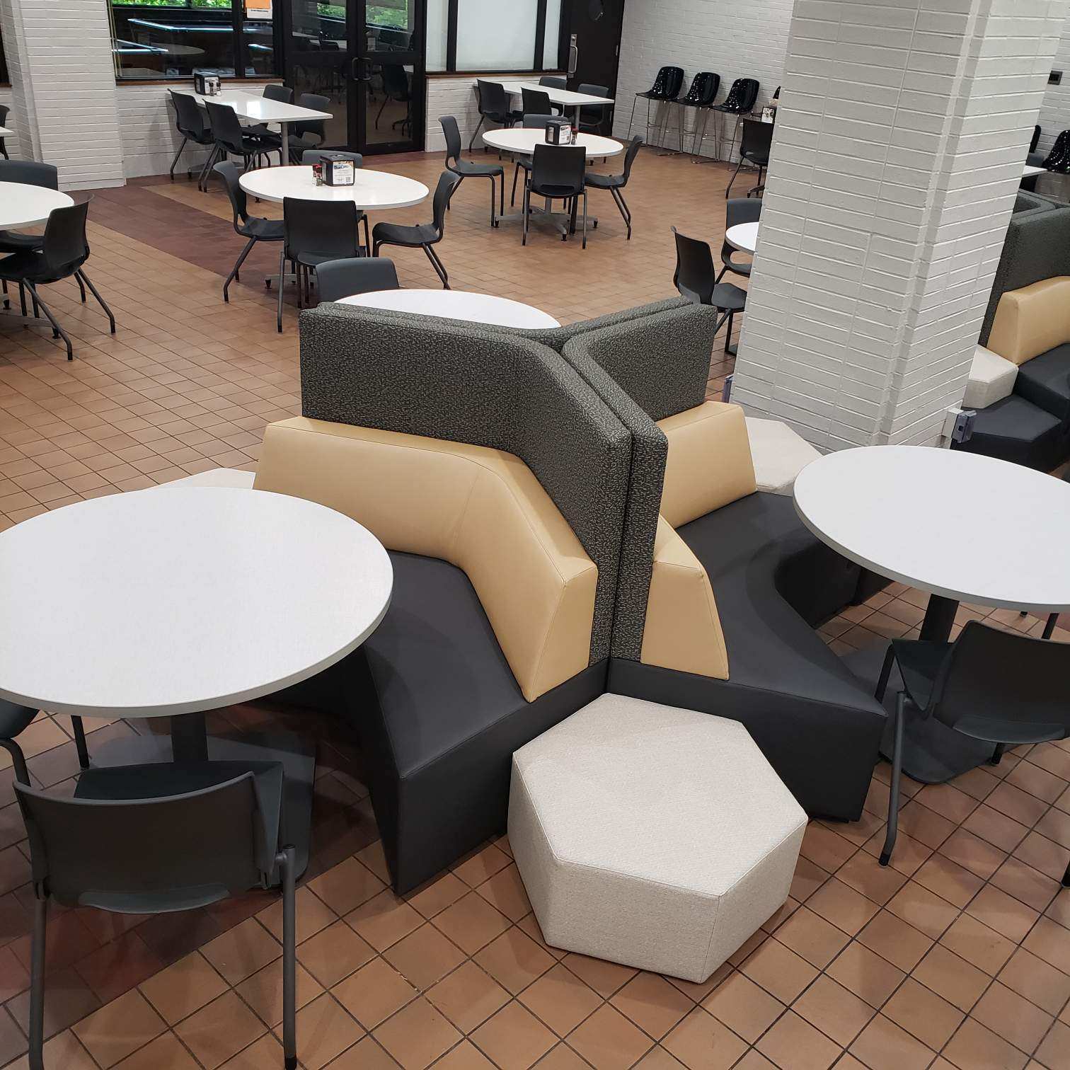 Corner couch seating featuring gold, grey, and black Corner couch seating featuring gold, grey, and black