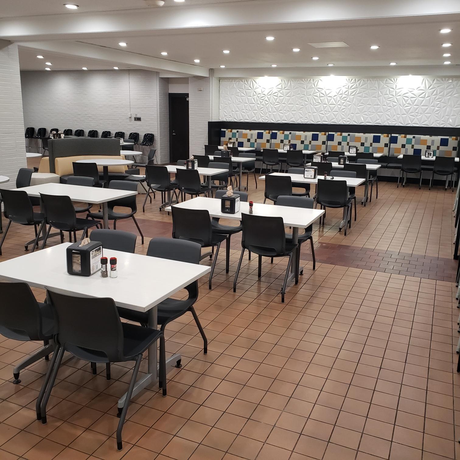 Wide view of multiple tables and couches in the cafe Wide view of multiple tables and couches in the cafe