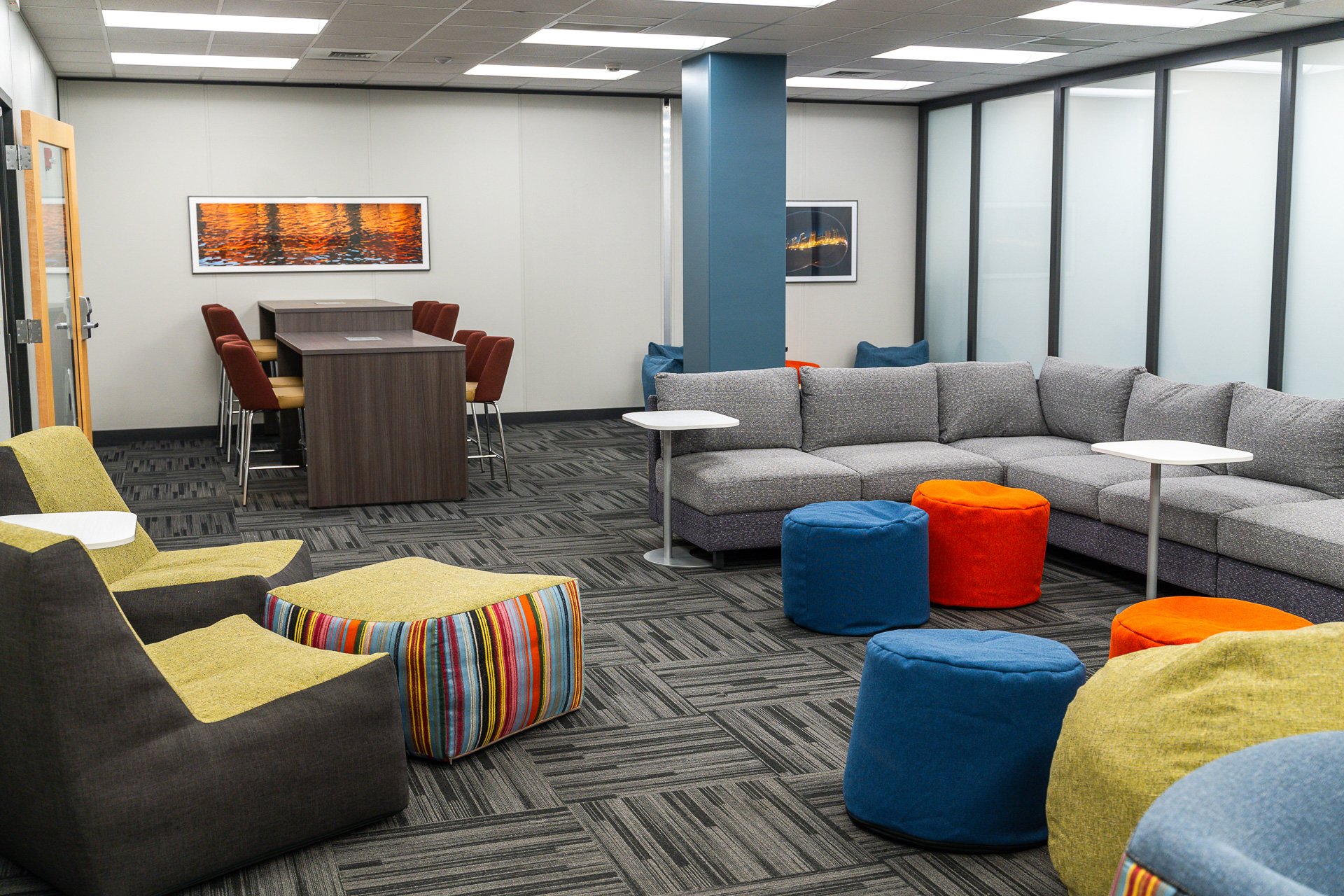 Multi-colored bean bags with tables and a multi-height table Multi-colored bean bags with tables and a multi-height table