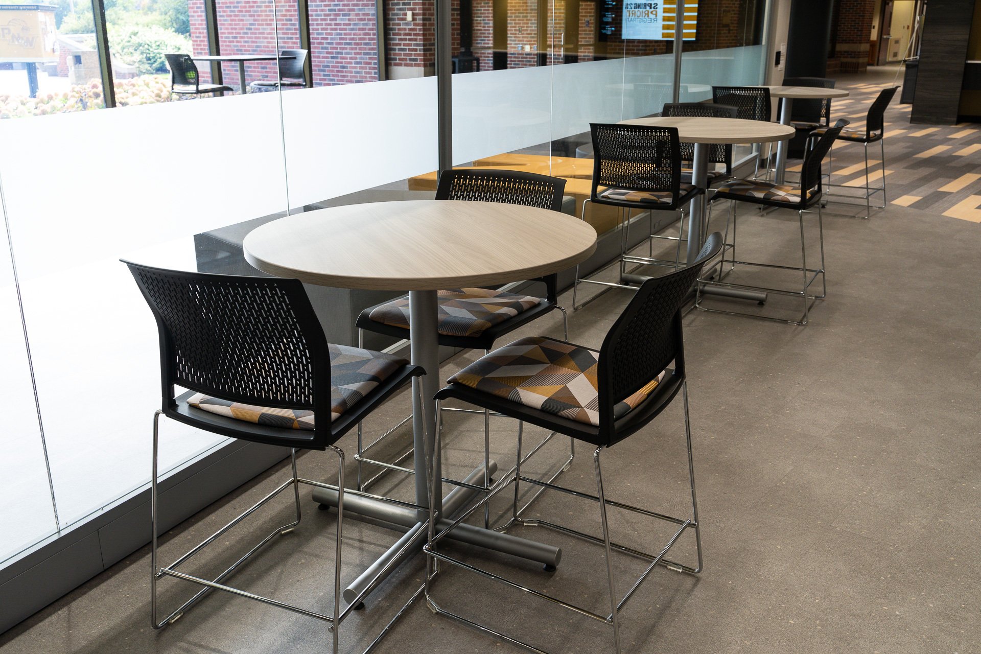 Tables and chairs line a partially frosted window Tables and chairs line a partially frosted window