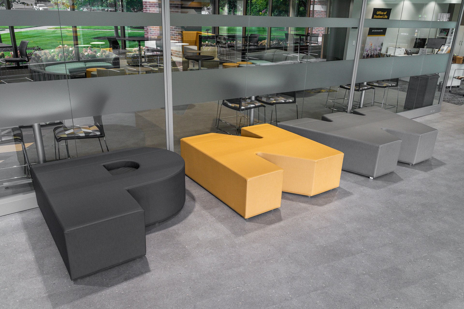 Large PNW letters in front of windows Large PNW letters in front of windows