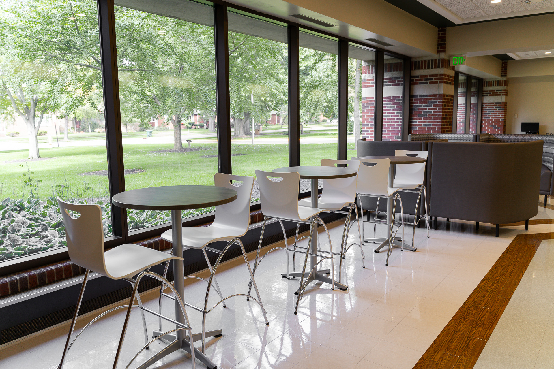 Chairs and tables seated in front of windows
