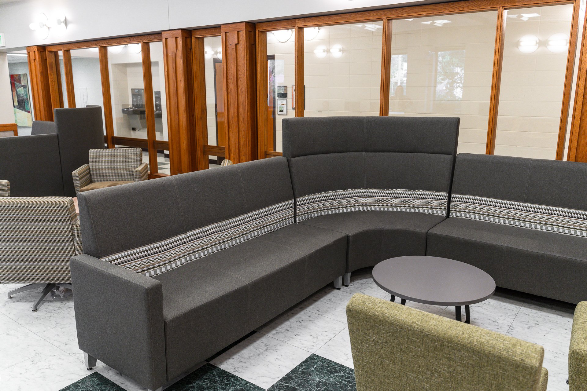 Large couch sits in front of windows Large couch sits in front of windows