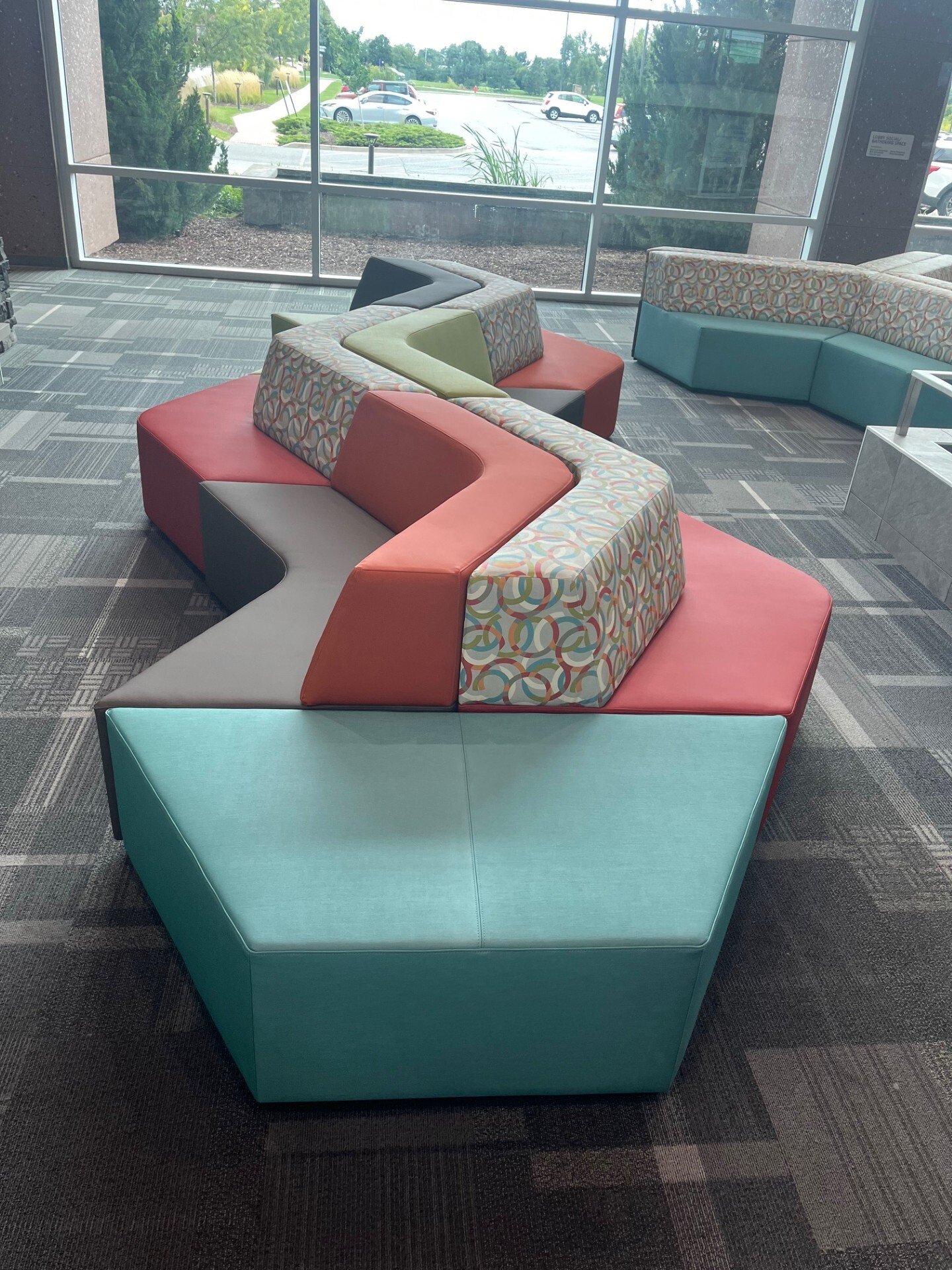 Vertical view of the centerpiece couch within the YMCA lobby